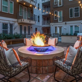 Courtyard with firepit Courtyard with fire pit surrounded by cushioned chairs